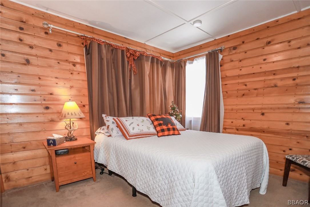 39016 1/2 Robin Road Big Bear Lake, CA 92315 - Photo 13 of 23 a bedroom with a bed and a dresser