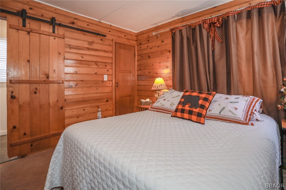 39016 1/2 Robin Road Big Bear Lake, CA 92315 - Photo 15 of 23 a bedroom with a bed and a window