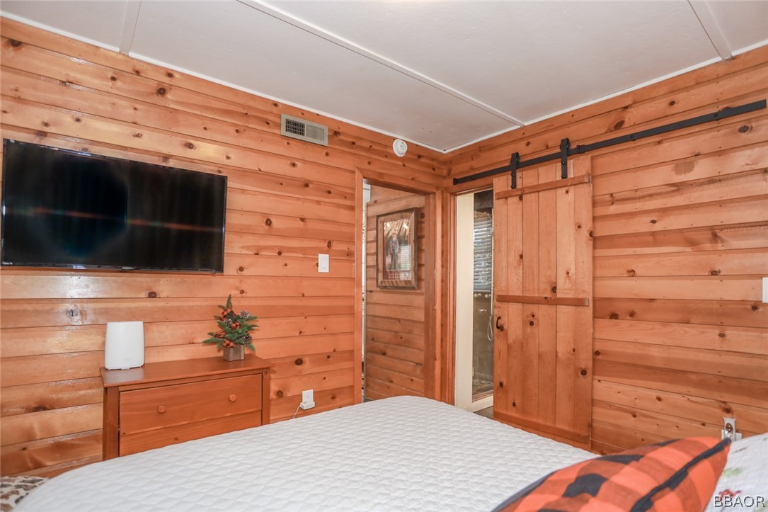 39016 1/2 Robin Road Big Bear Lake, CA 92315 - Photo 16 of 23 a bathroom with a sink a mirror and shower
