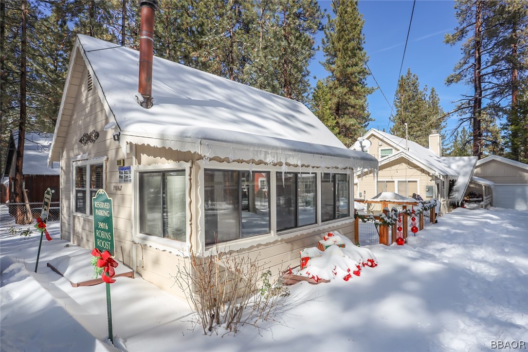 39016 1/2 Robin Road Big Bear Lake, CA 92315 - Photo 2 of 23 a view of a white house with a potted plant and a yard