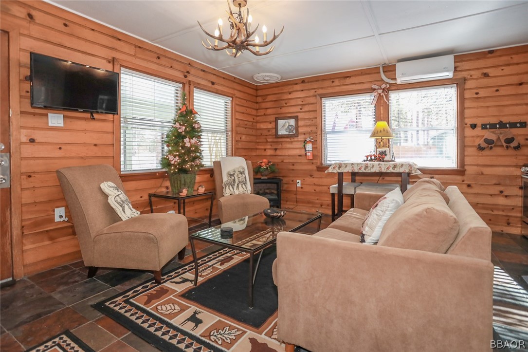 39016 1/2 Robin Road Big Bear Lake, CA 92315 - Photo 6 of 23 a living room with furniture and a flat screen tv