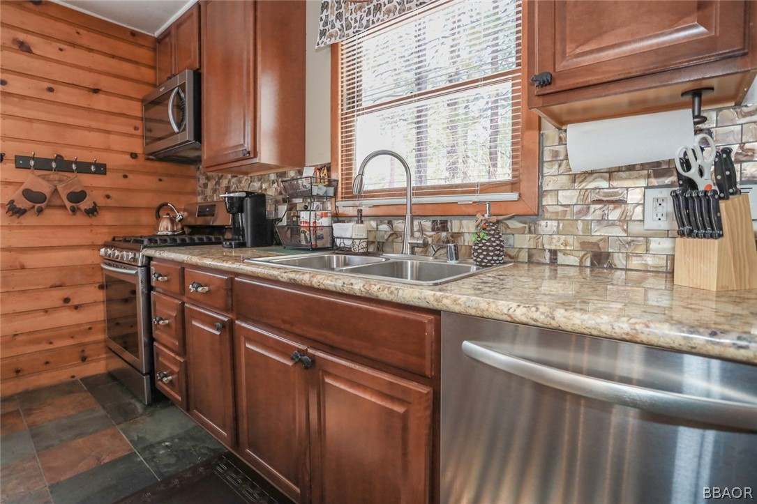 39016 1/2 Robin Road Big Bear Lake, CA 92315 - Photo 7 of 23 a kitchen with stainless steel appliances granite countertop a sink a stove and a wooden cabinets
