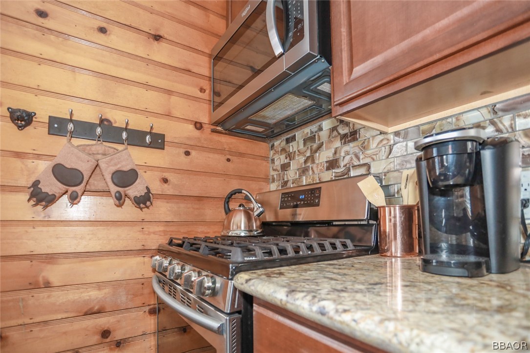 39016 1/2 Robin Road Big Bear Lake, CA 92315 - Photo 8 of 23 a kitchen with a stove and cabinets