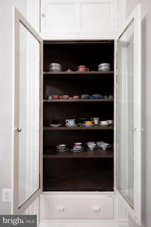 a kitchen with granite countertop stainless steel appliances wooden cabinets and a refrigerator