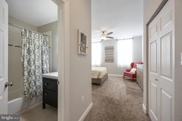 a bedroom with a bed and ceiling fan