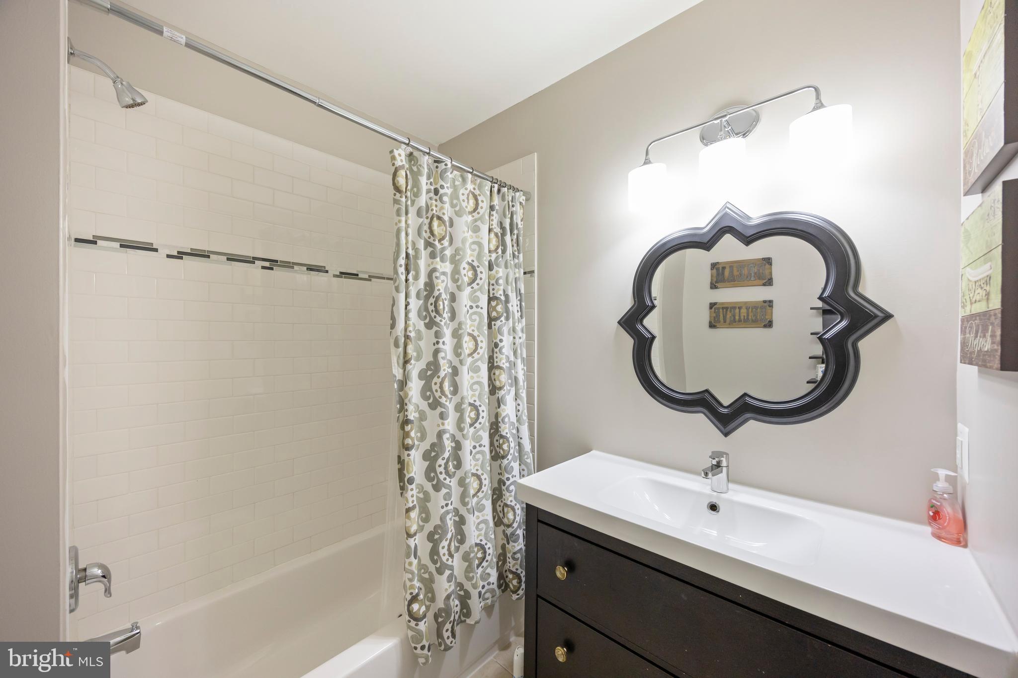 314 East 22nd Street Baltimore, MD 21218 - Photo 20 of 34 a bathroom with a sink and a mirror