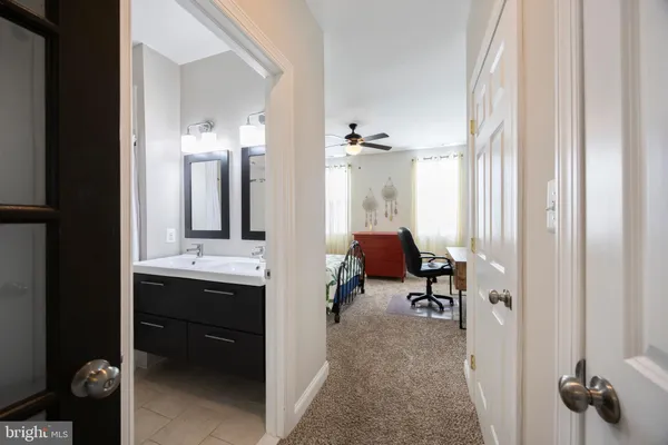 a bathroom with a tub sink double and mirror