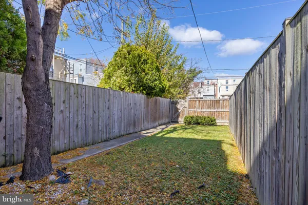 a view of backyard with wheel chair and potted plants
