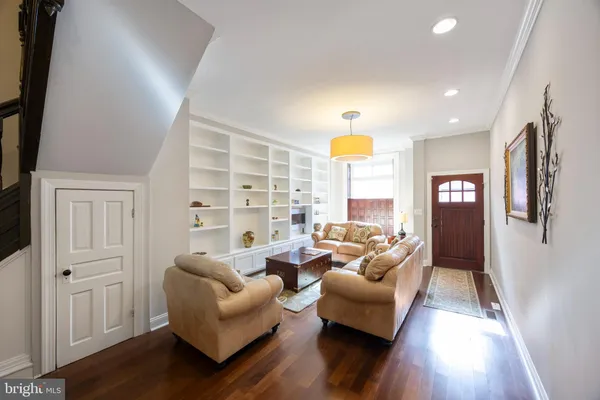 a living room with furniture a rug and a window