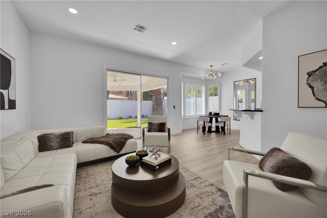 8981 Rivers Edge Drive Las Vegas, NV 89117 - Photo 11 of 69 A luminous living space features generous sliding glass doors leading to a private outdoor area.