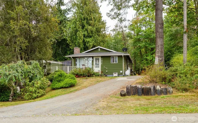 a front view of a house with a yard table and chairs