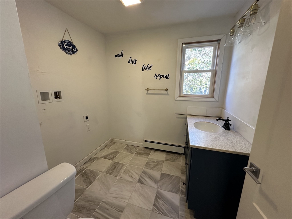 8 Pike Street Hopkinton, MA 01748 - Photo 25 of 34 a bathroom with a sink and a mirror