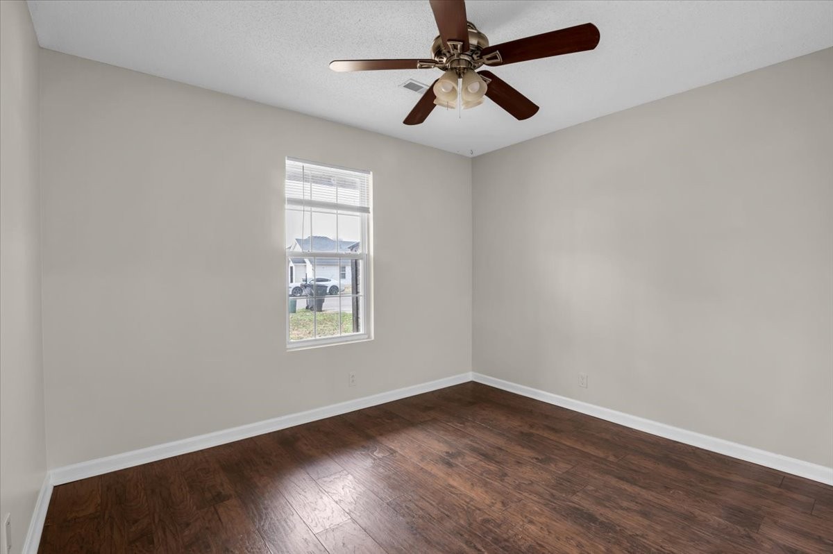 2765 Windwalker Court Murfreesboro, TN 37128 - Photo 11 of 31 an empty room with wooden floor ceiling fan and windows