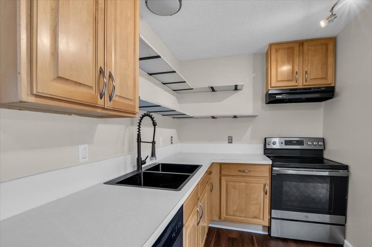 2765 Windwalker Court Murfreesboro, TN 37128 - Photo 13 of 31 a kitchen with stainless steel appliances granite countertop a stove and a microwave with white cabinets