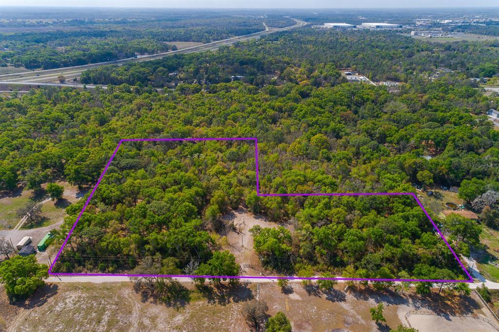 16612 Auburndale Lane Spring Hill, FL 34610 - Photo 1 of 1 an aerial view of residential house with outdoor space and trees all around