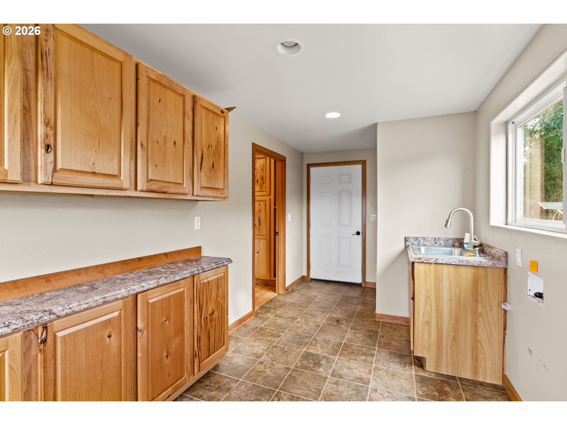 7470 Maple Creek Road Westlake, OR 97493 - Photo 12 of 33 a hallway with sink and cabinets