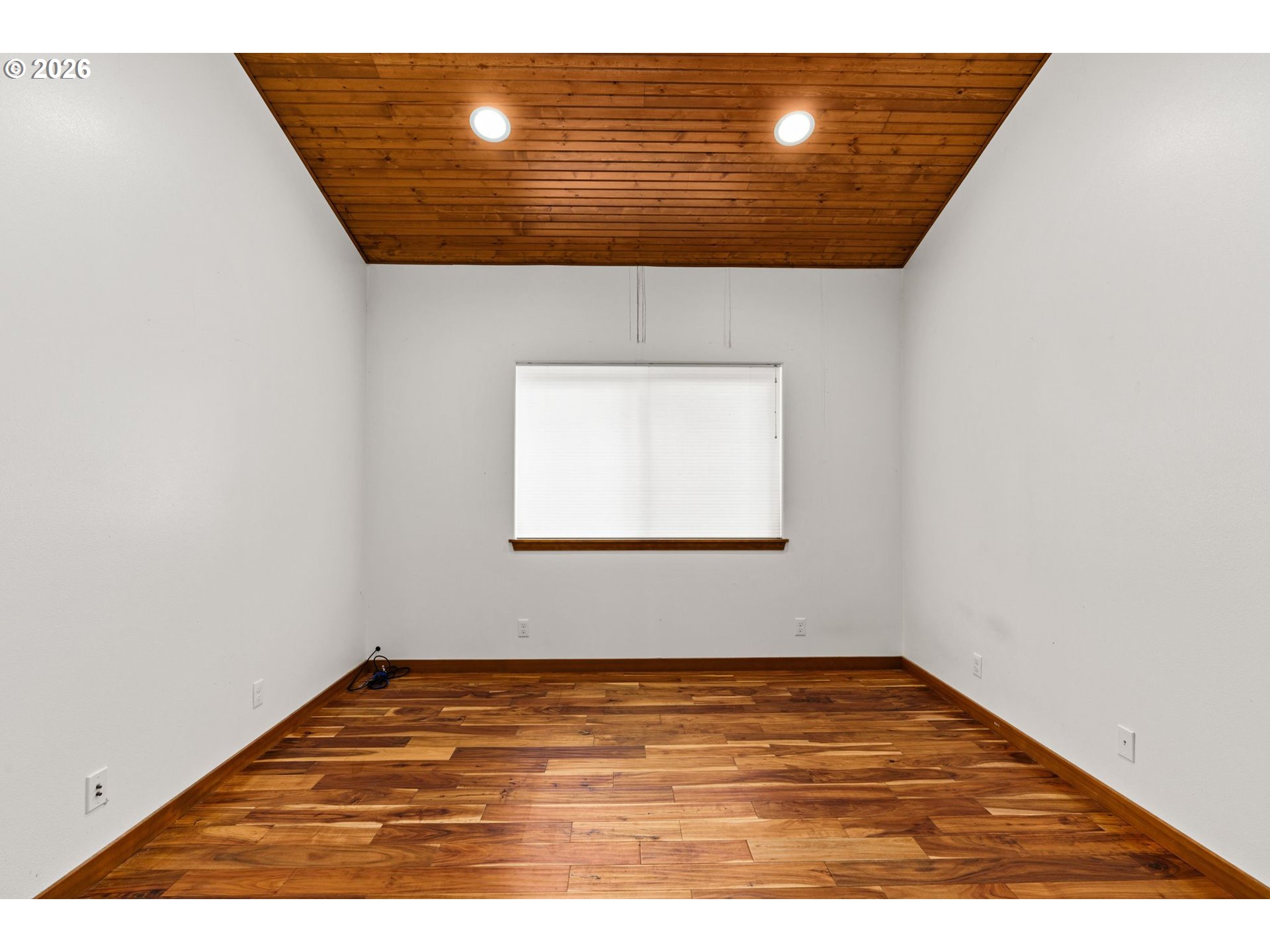 7470 Maple Creek Road Westlake, OR 97493 - Photo 19 of 33 a view of an empty room with wooden floor and a window