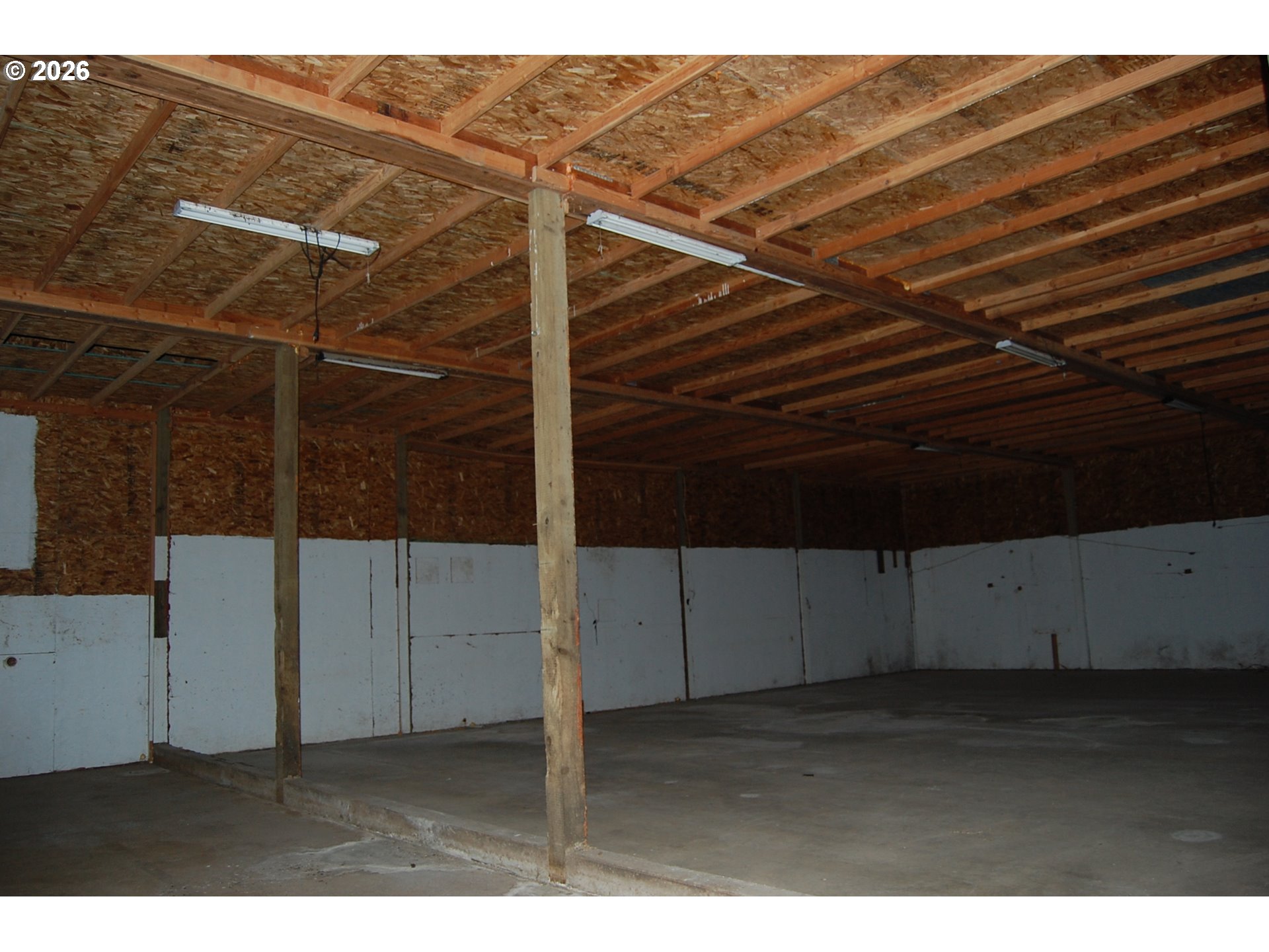 7470 Maple Creek Road Westlake, OR 97493 - Photo 31 of 33 a view of an empty room with wooden floor