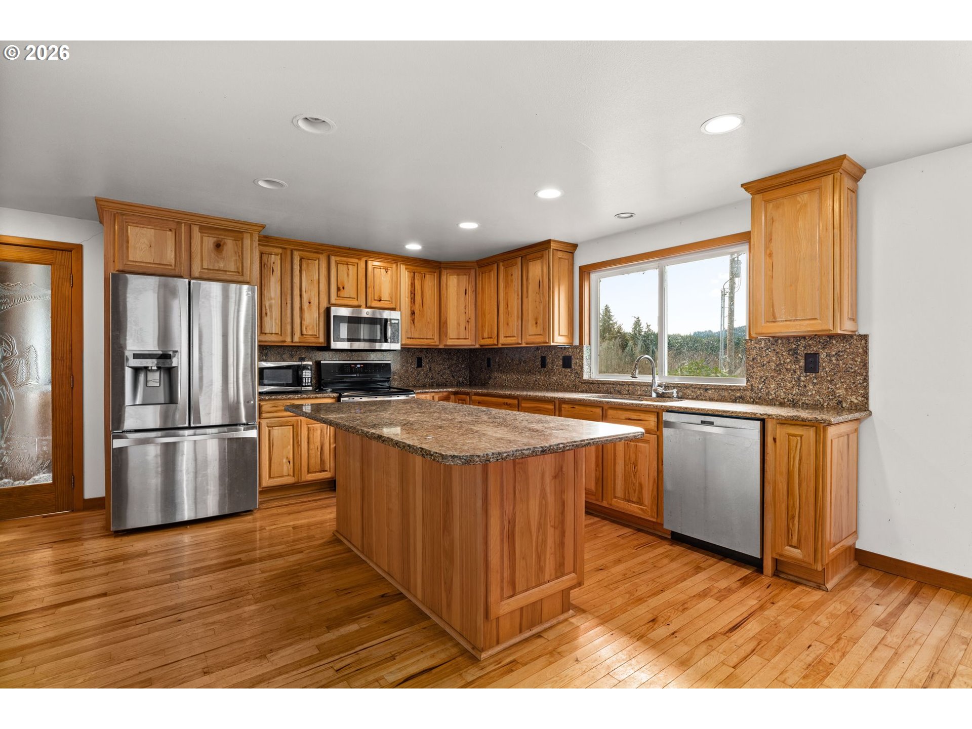 7470 Maple Creek Road Westlake, OR 97493 - Photo 8 of 33 a kitchen with stainless steel appliances granite countertop a refrigerator a sink dishwasher a stove and white countertops with wooden floor