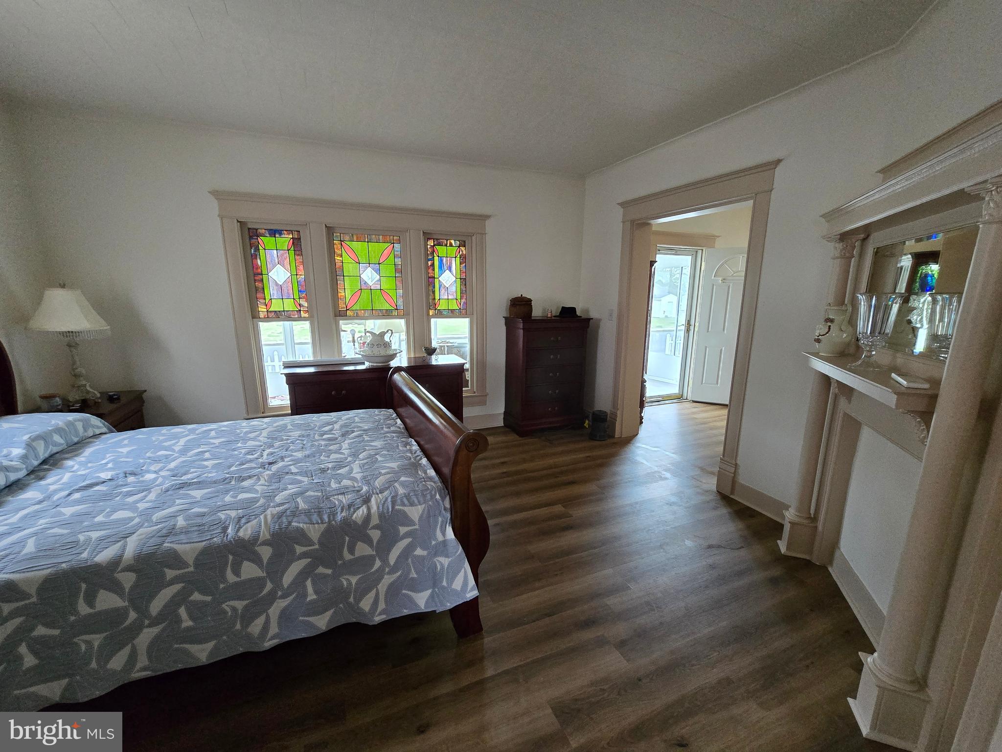 205 Myrtle Street Crisfield, MD 21817 - Photo 23 of 56 a spacious bedroom with a bed and wooden floor