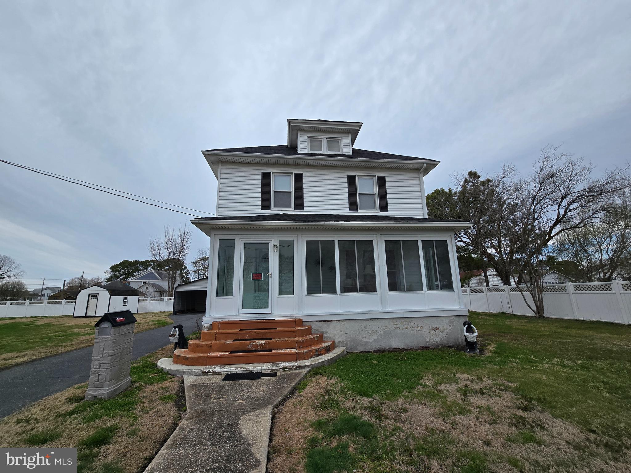 205 Myrtle Street Crisfield, MD 21817 - Photo 4 of 56 a house that has a big yard with plants and trees