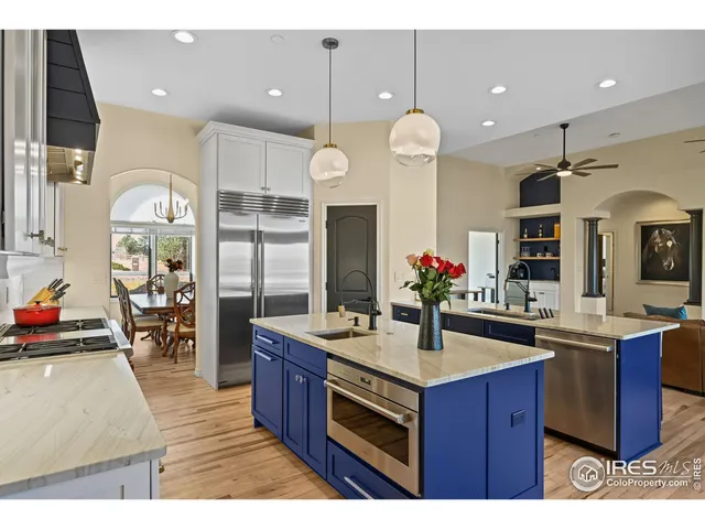 a kitchen with counter top space and living room view