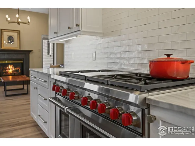a kitchen with stainless steel appliances granite countertop a stove and a sink