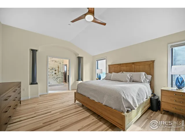 a bedroom with a bed a dresser and painting on the wall