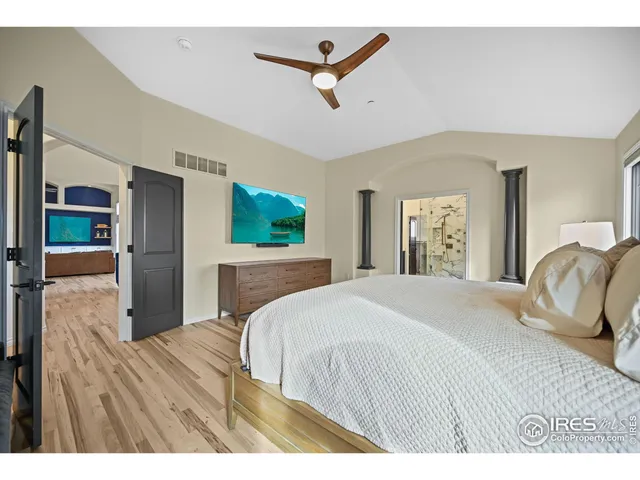 a bedroom with a large bed and a chandelier