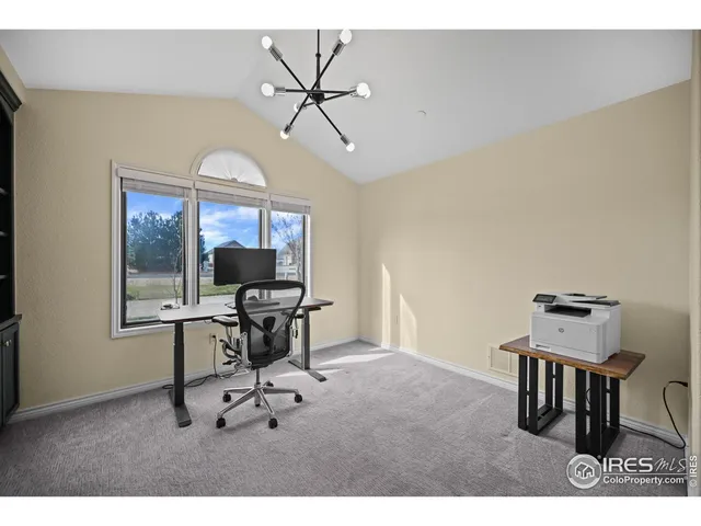 a workspace with wooden floor a glass table and chairs