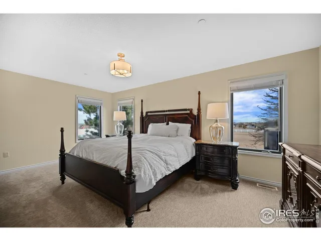 a bed room with a bed window and a chair