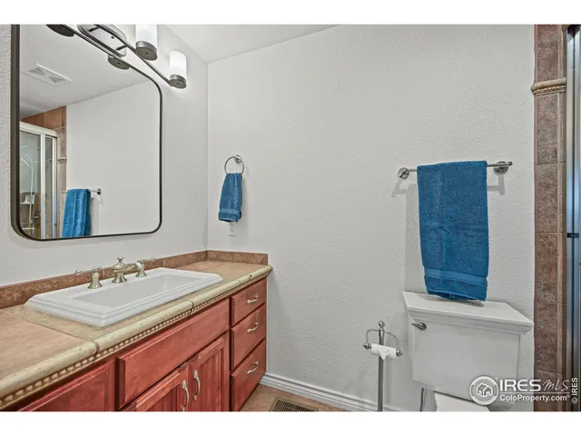 a bathroom with a sink vanity and mirror