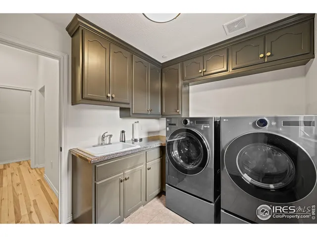 a utility room with sink dryer and washer