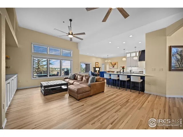 a living room with furniture and kitchen view