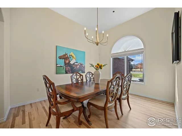 a view of a dining room with furniture and chandelier