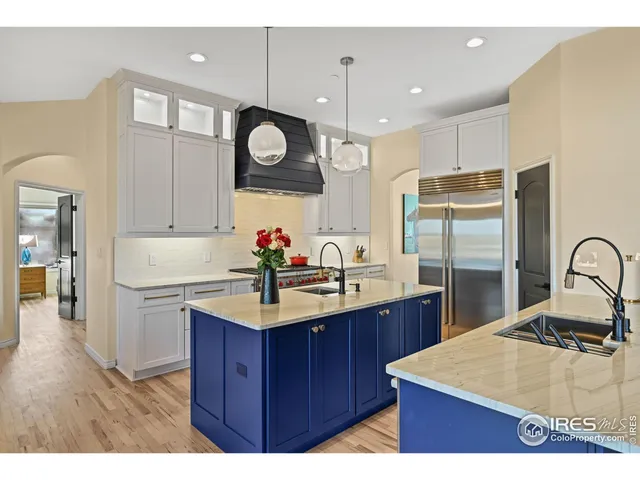 a kitchen with a sink a stove and cabinets