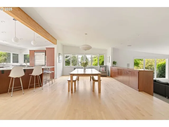 a dining room with furniture and wooden floor