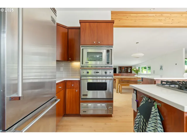 a kitchen with stainless steel appliances kitchen island granite countertop a stove a sink and a microwave