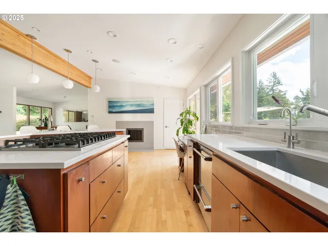 a kitchen with a sink window and cabinets