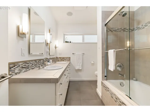 a bathroom with a toilet sink and a mirror