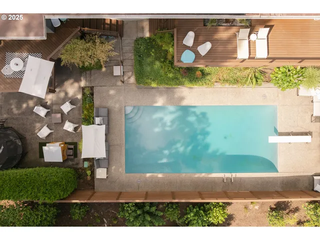 a view of a patio with table and chairs with wooden floor and fence