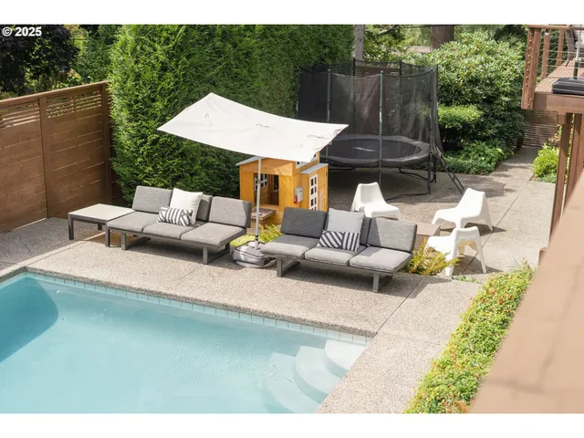 a backyard of a house with table and chairs