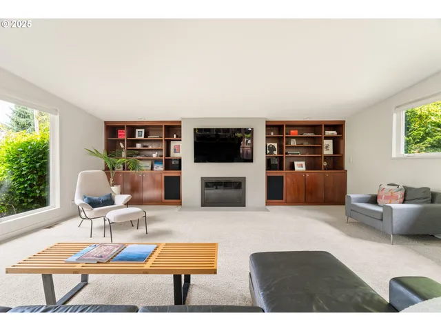 a living room with furniture a rug and a flat screen tv