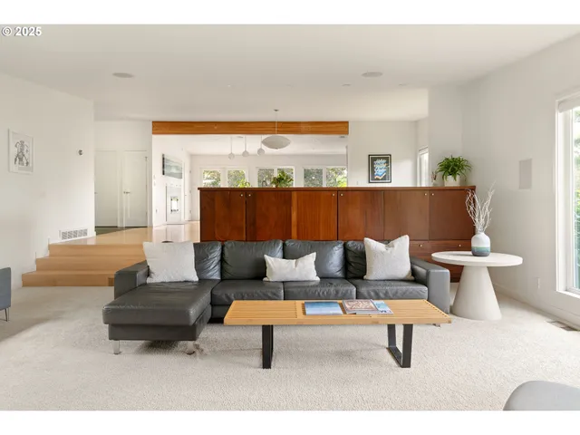 a living room with furniture and a night stand