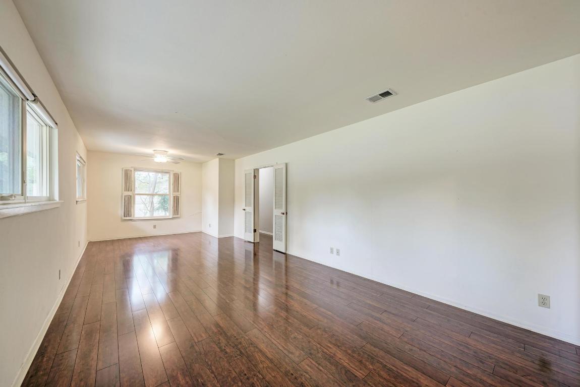 2500 Spring Creek Drive Austin, TX 78704 - Photo 11 of 40 a view of an empty room with wooden floor and a window