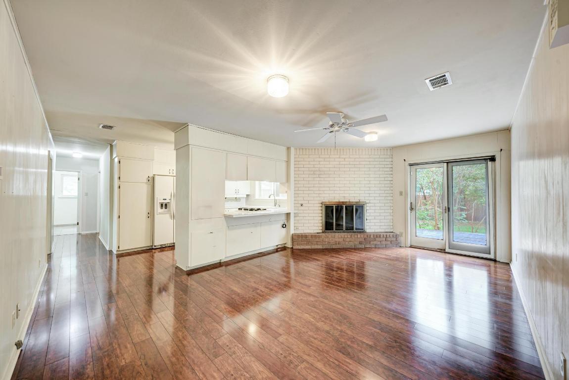 2500 Spring Creek Drive Austin, TX 78704 - Photo 13 of 40 a view of a kitchen with a stove cabinets and wooden floor