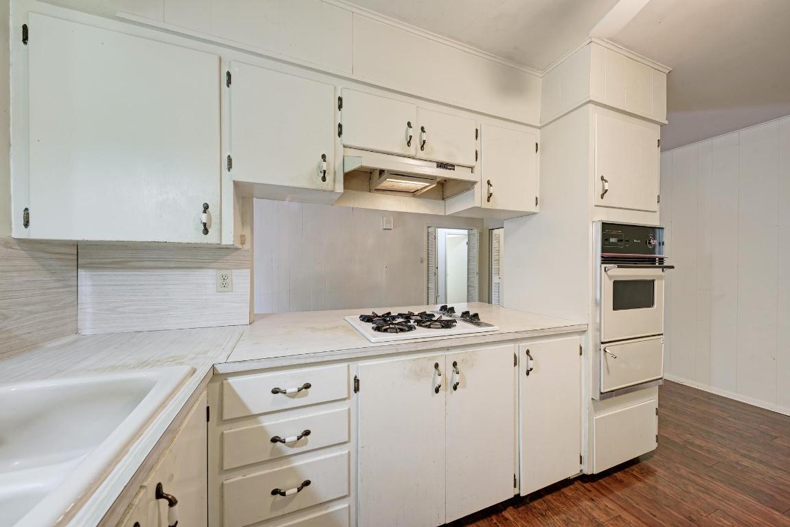 2500 Spring Creek Drive Austin, TX 78704 - Photo 18 of 40 a kitchen with cabinets and wooden floor