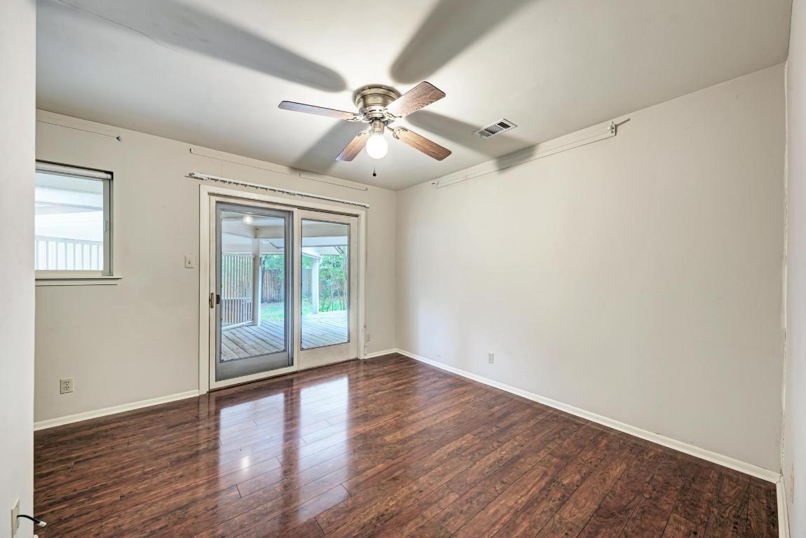 2500 Spring Creek Drive Austin, TX 78704 - Photo 27 of 40 a view of an empty room with wooden floor and a window