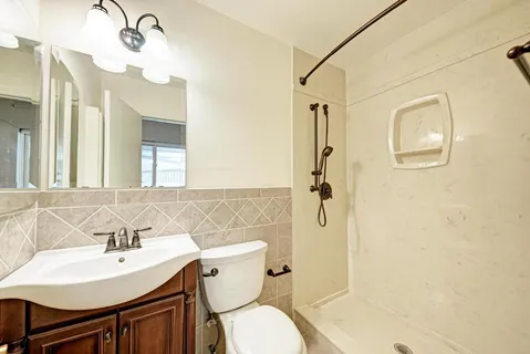 a bathroom with a sink toilet and shower