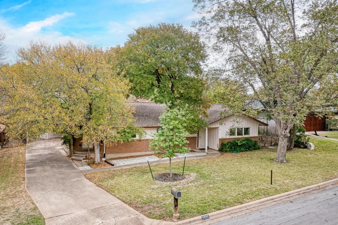 2500 Spring Creek Drive Austin, TX 78704 - Photo 4 of 40 a swimming pool with outdoor seating and yard